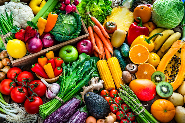 picture of assorted vegetables and fruits such as kiwis, avocados, bell peppers and tomatoes.