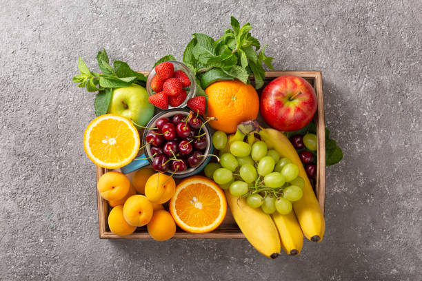 picture of assorted fruits such as bananas, oranges, cherries and grapes.